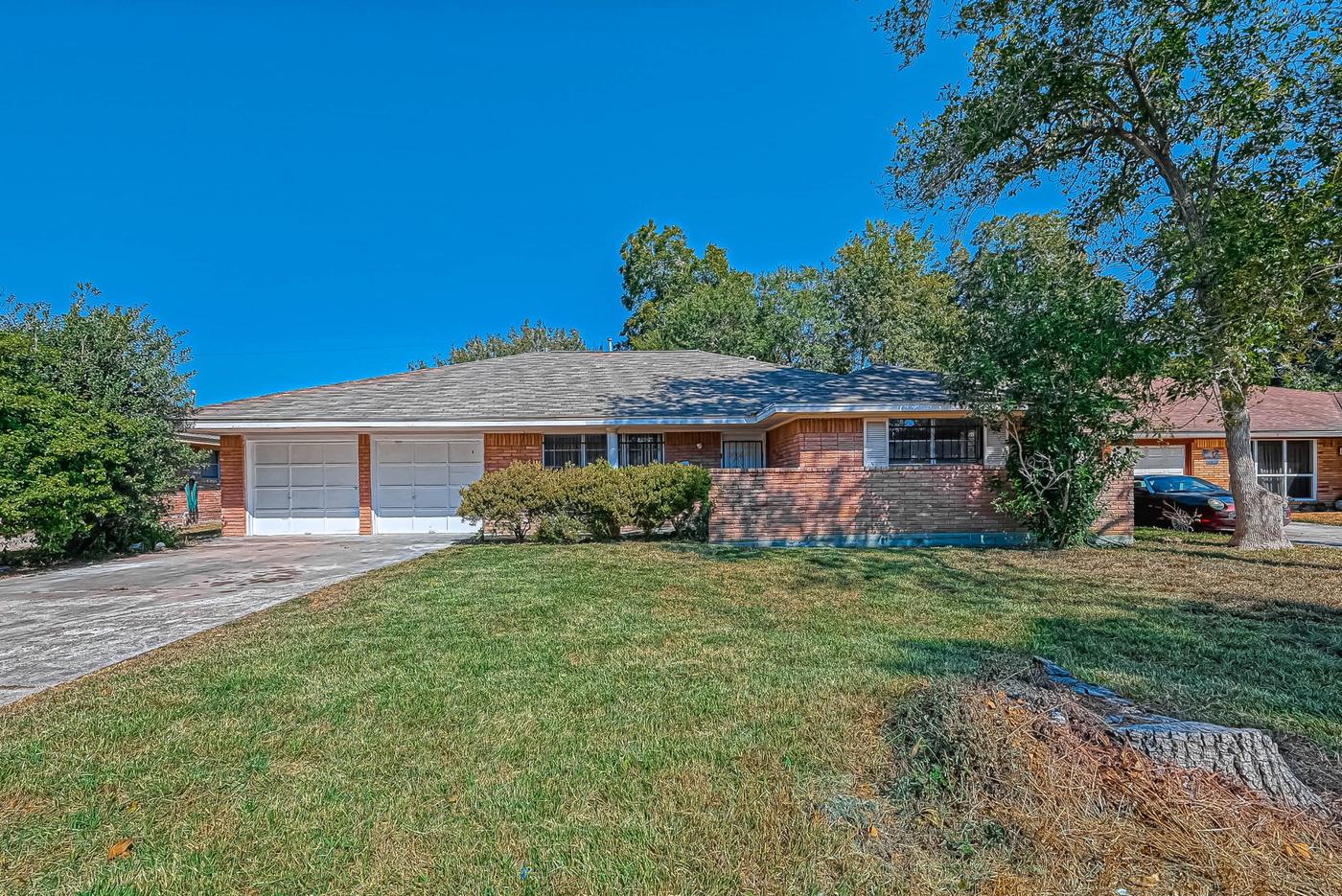 One of the brick single-family homes in the portfolio, with a two-car garage